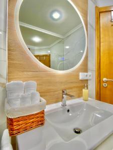 a bathroom with a white sink and a mirror at Casa dos sonhos in Chaves