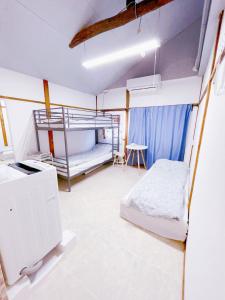 a room with two bunk beds and a table at Akira&chacha杉並区世田谷direct to shinjuku for 13 min 上北沢4分 近涉谷新宿 in Tokyo