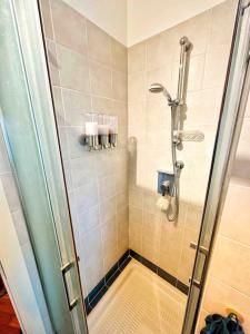 a shower with a glass door in a bathroom at Meizon Business Tower, Imbarco traghetti Sicilia e Sardegna, terrazzo esclusivo, Wi-Fi Super veloce, parcheggio riservato in Genoa