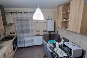 a kitchen with a table and a kitchen with a tableablish at Locul unde te simți acasă in Câmpulung