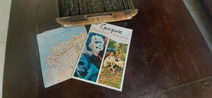 a book sitting on top of a table with a map at Le Patio Fleuri - Studio et terrasse privé à Cayenne in Cayenne