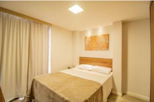 a bedroom with a bed and a window at TaguaPark Hotel in Taguatinga