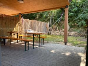 a pavilion with two benches and a swing at SKH R - 1 Bedroom in Praid +11 photos