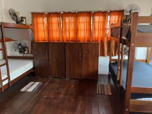 a room with a bunk bed and wooden cabinets at Tanty’s Hostel in Galle