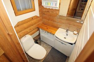 a tiny bathroom with a toilet and a sink at Saremökki in Kittilä +23 photos