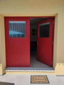 une porte rouge avec un panneau devant elle dans l'établissement Casa Giuditta, à Civezzano