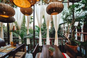 a restaurant with a wooden table and some plants at La Ferme Medina in Marrakesh