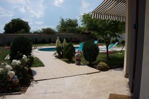 a backyard with a swimming pool with a fire hydrant at Guest House Golden Flake 4km from Bolata beach in Bŭlgarevo