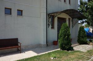 a building with a bench in front of a door at Guest House Golden Flake 4km from Bolata beach in Bŭlgarevo