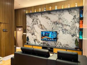 a lobby with a large wall with a tv on it at Hotel Marudu Inn 
