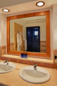 a bathroom with two sinks and a large mirror at Sheraton Miramar Resort El Gouna in Hurghada