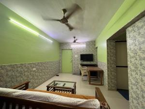 a living room with a couch and a table at Galaxy Apartment in Mumbai