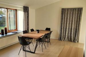 a dining room with a wooden table and chairs at SoloRica House(400m to Lego House,1km to Legoland) in Billund