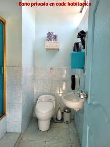 a bathroom with a toilet and a sink at MAGICPERU PET FRiENDLY in Trujillo