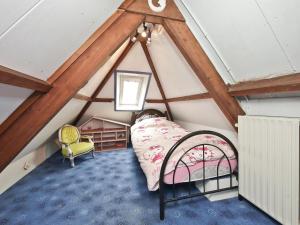 a room with a bed in a attic at Characteristic country house with wellness in Lijnden