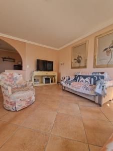 a living room with a couch and a tv at Grand appartement 4-8 personnes in Montreux