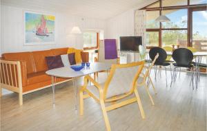 KlegodにあるBeautiful Home In Ringkbing With 3 Bedrooms, Sauna And Wifiのリビングルーム(ソファ、テーブル、椅子付)