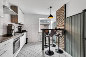 a kitchen with a table and two stools at STANMA Hirschtraum in Braunlage