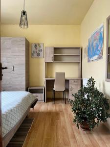 a bedroom with a bed and a desk and a chair at TREFOIL in Lori Berd
