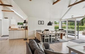 a kitchen and living room with a couch and a table at 3 Bedroom Amazing Home In Silkeborg in Silkeborg