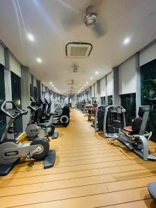 a gym with a row of treadms and cardio machines at Vortex suites klcc by Yashrib in Kuala Lumpur