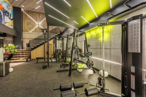 a gym with several treadmills and weights at Mava Apartamente in Constanţa