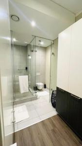 a bathroom with a glass shower and a toilet at The Comfort AirB&B - Top floor luxury 1 bedroom apartment with views in Pretoria