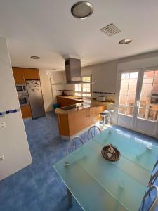 a kitchen with a glass table and chairs in it at Casa Rural Goñi in Cabañas de Ebro