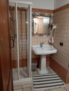 a bathroom with a sink and a shower at Il Casale dell'Acquabona in Montefano
