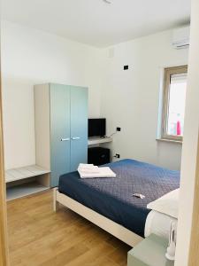 a bedroom with a blue bed and a desk at Civico 185 in Acri