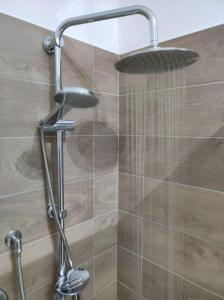 a shower with a shower head in a bathroom at Civico 185 in Acri +28 photos