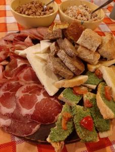 a plate of food with meats and cheese and other foods at Il Casale dell'Acquabona in Montefano +60 photos