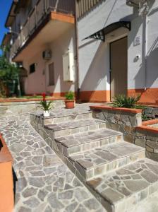 a stone walkway in front of a building at Civico 185 in Acri