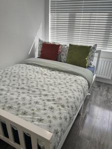 a bedroom with a bed with a white bed frame at Modern Comfy One Bed Apartment - Free Parking in Glasgow