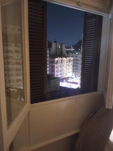 a window with a view of a city at night at New Panorama Palace in Cairo