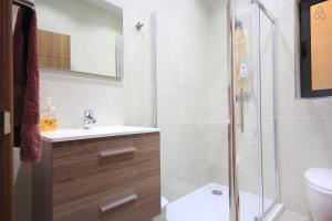 a bathroom with a shower and a sink and a toilet at Étoile Court Apt - homey, spacious & private patio in Mġarr +29 photos