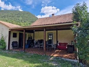 a house with a patio with a table and chairs at Chambre aux Gorges de Daluis in Guillaumes