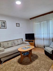a living room with a couch and a coffee table at Dijanin Konak in Zvornik
