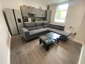 a living room with a couch and a coffee table at ENTIRE MODERN HOUSE in Elland