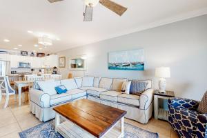 a living room with two couches and a table at Marlin Key 2D in Orange Beach