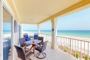 a balcony with a table and chairs and the ocean at Marlin Key 2D in Orange Beach