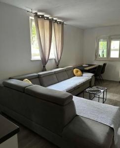 a living room with a couch and a table at Gabine - Self Check-in in Kaštela