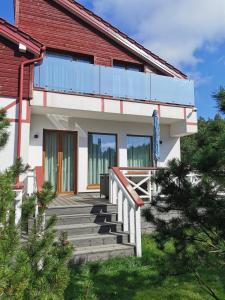 a house with a staircase in front of it at Beach Lounge Luxory Apartments in Klaipėda