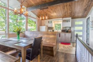 a kitchen and dining room with a wooden table at Nordika Lac St Pierre No. PERMIS CITQ: 298304 in Val des Monts +11 photos