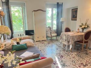 a living room with a couch and a table at Les Coulisses de l'HORLOGE - WIFI - 50 m Palais des Papes in Avignon