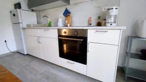 a kitchen with a stove and a refrigerator at Apartment Tea 2 in Okrug Donji