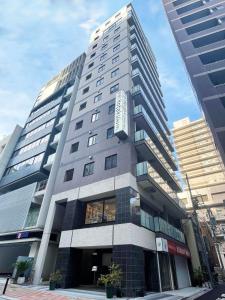 東京にあるHotaku HOTEL Akihabaraの看板が横に建つ高層ビル