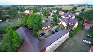 an aerial view of a house with cars parked in a yard at Dolistówka in Goniadz