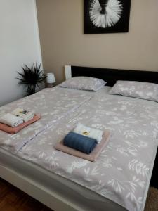 a bed with two towels on top of it at Apartma JERMAN - Cerknica in Cerknica