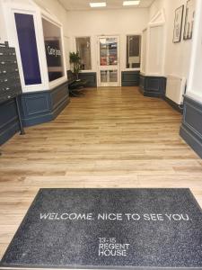 a welcome mat in the lobby of a store at Regent Penthouse in Harrogate